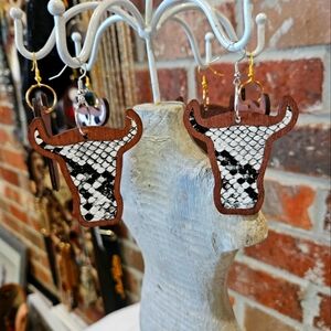 Rockin' Hot Originals cow earrings snakeskin material laid in dark wood